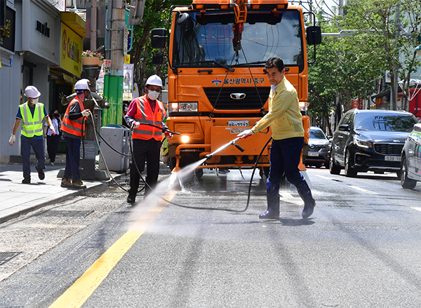 김영길 중구청장이 7일 폭염 피해를 예방하기 위해 중구 시계탑사거리 주변도로에서 뜨겁게 달궈진 도로에 직접 물을 뿌리고 있다.